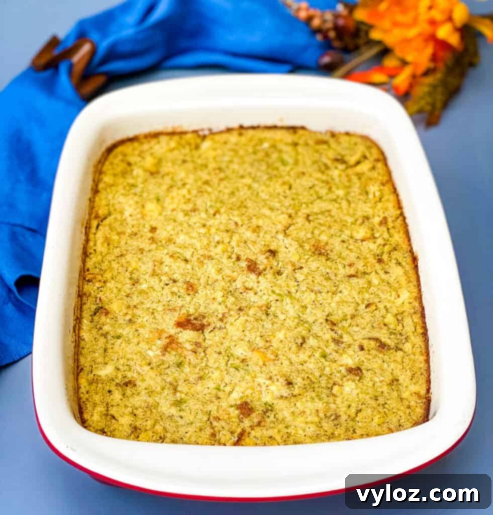 Freshly baked cornbread dressing, golden brown and fragrant, cooling in its baking dish after being removed from the oven.