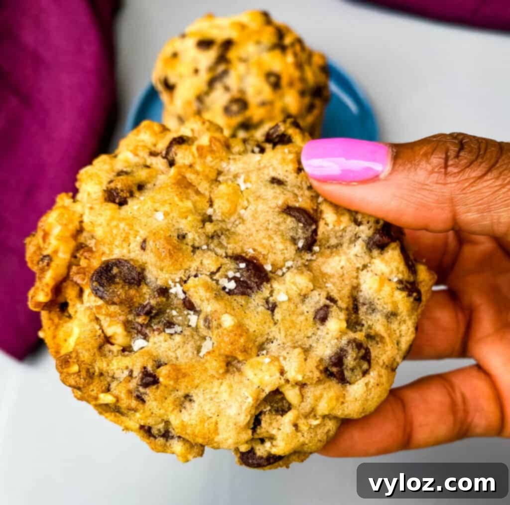 person holding a freshly baked air fryer chocolate chip cookie