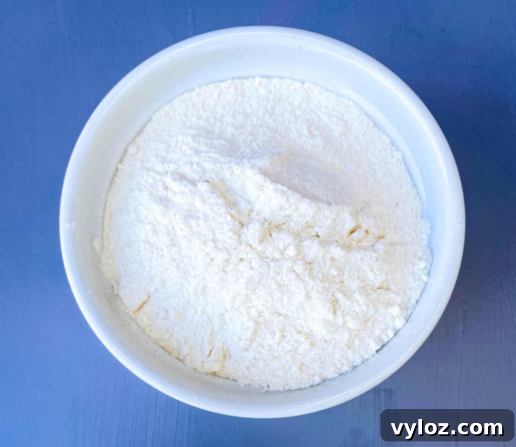 all purpose flour in a white bowl, a key ingredient for air fryer chocolate chip cookies