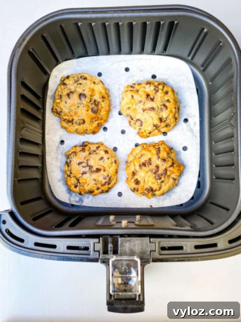 freshly baked air fryer chocolate chip cookies in an air fryer basket