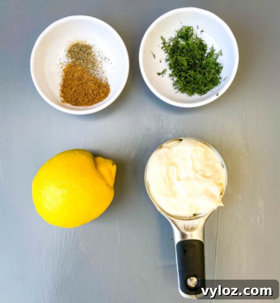 Effortless Crab Salad 4 Old Bay seasoning, fresh dill lemon, and mayo on a flat surface