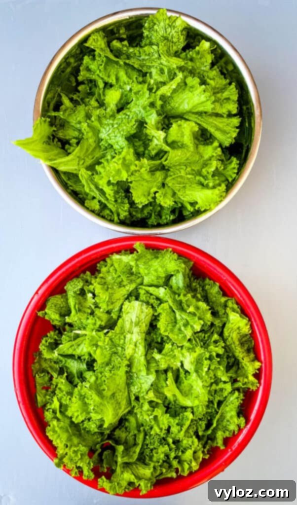 Two bowls filled with fresh and thoroughly washed mustard greens, ready for cooking.
