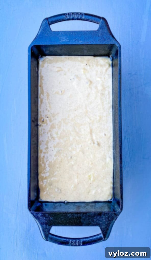 Healthy sugar-free banana bread baking in a loaf pan, showing a golden-brown top