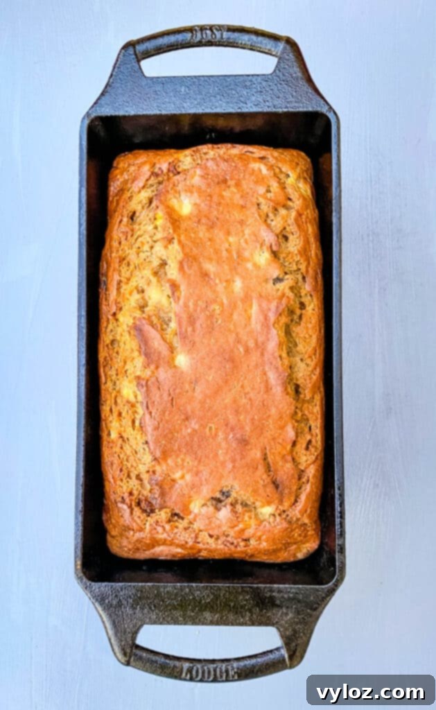 Another view of healthy sugar-free banana bread in a loaf pan, freshly baked and golden