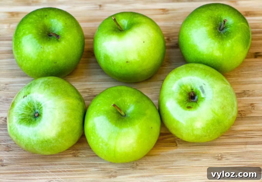 Granny Smith apples on a bamboo cutting board