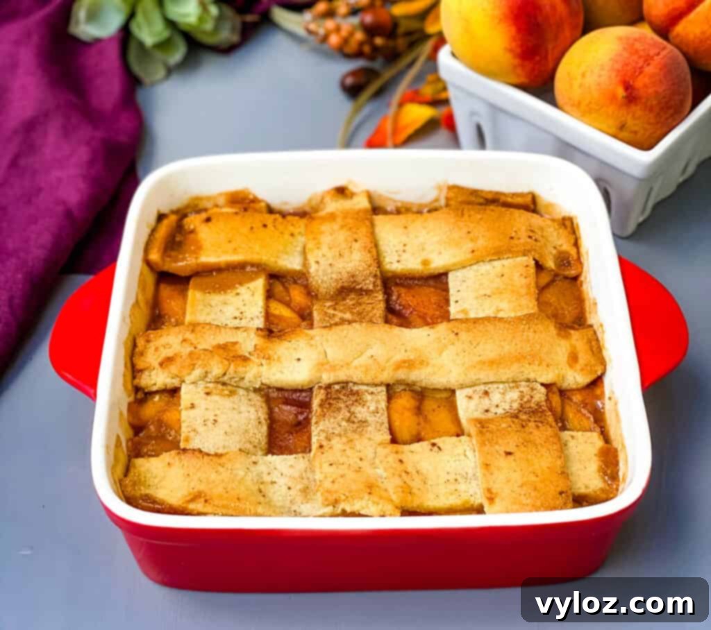 Healthy Southern peach cobbler in a red baking dish, freshly baked