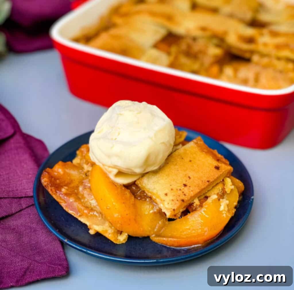 Healthy Southern peach cobbler on a blue plate with vanilla ice cream, a perfect dessert serving
