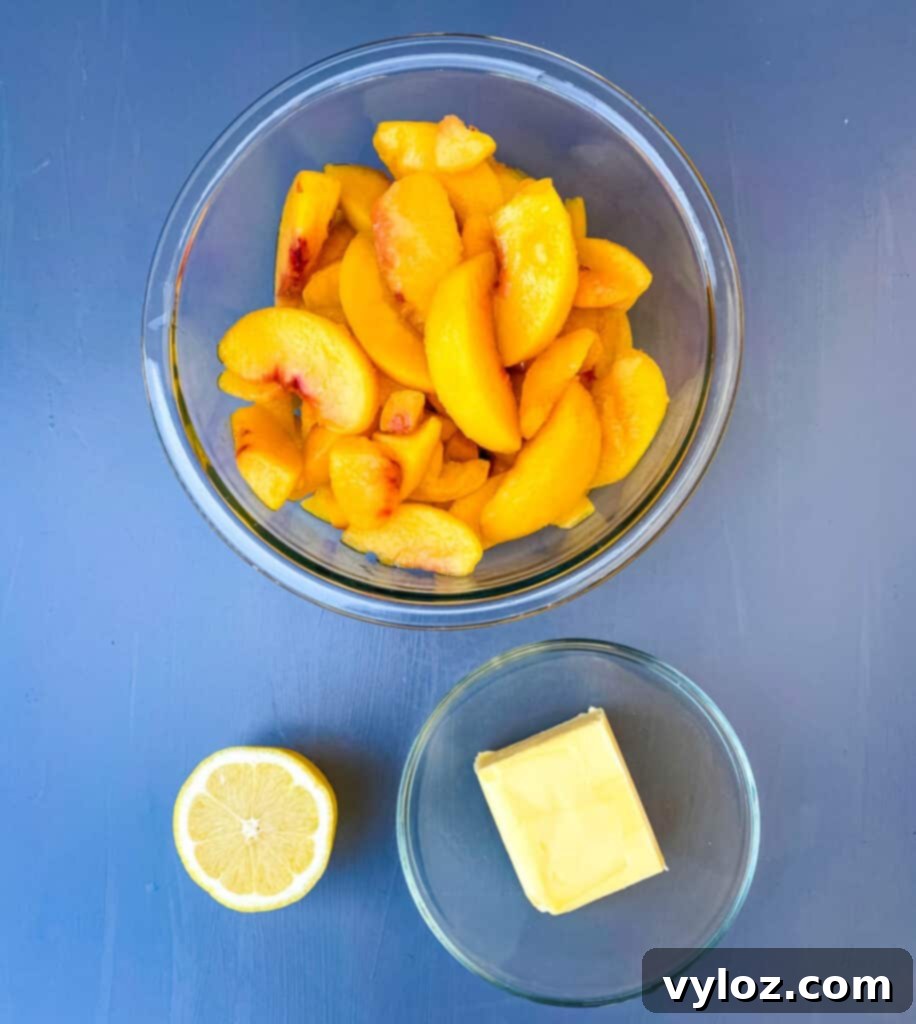 Frozen peaches, unsalted butter, and fresh lemon in separate bowls, key ingredients for a healthy cobbler