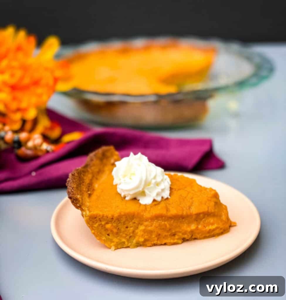 healthy sweet potato pie on a pie plate with whipped cream