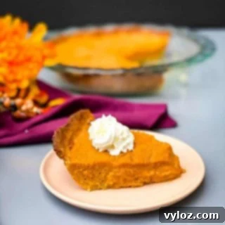 healthy sweet potato pie on a pie plate with whipped cream