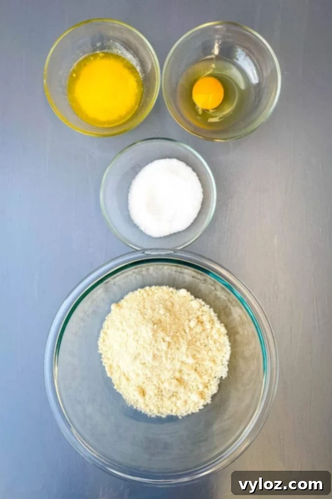 melted butter, raw egg, sweetener, and almond flour in separate glass bowls