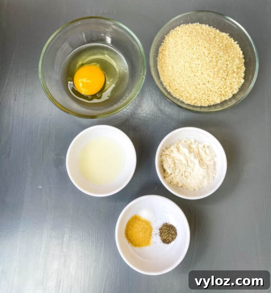 Crispy Air Fryer Fish Sandwich 5 Breading station setup with three bowls for flour, egg, and panko