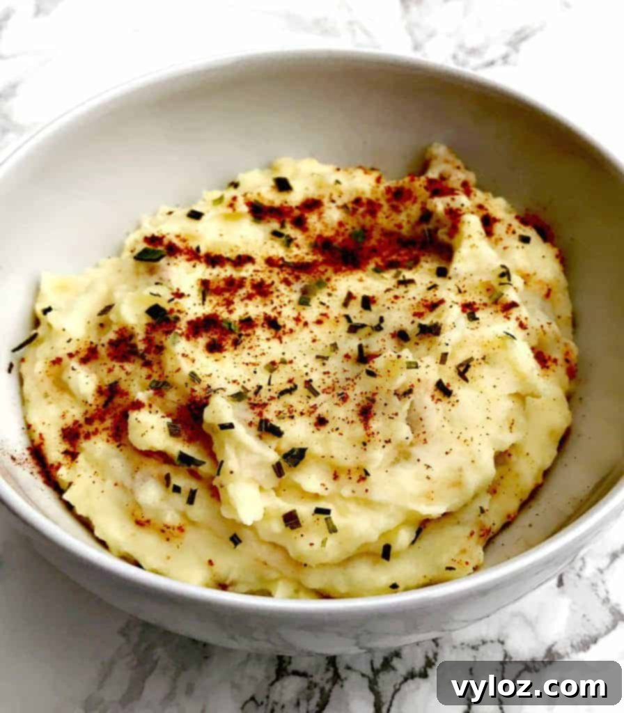 Rich and Creamy Dutch Oven Mashed Potatoes 7 Mashing skin-on potatoes in a Dutch oven