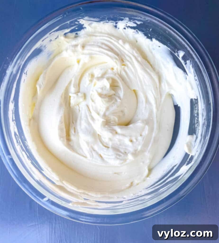 Final keto cheesecake filling mixture in a glass bowl before spreading