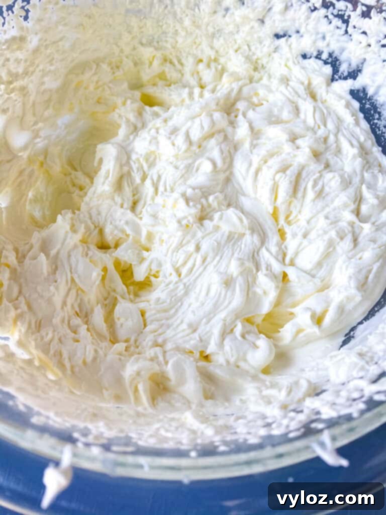 Whipped cream being gently folded into the keto cheesecake mixture