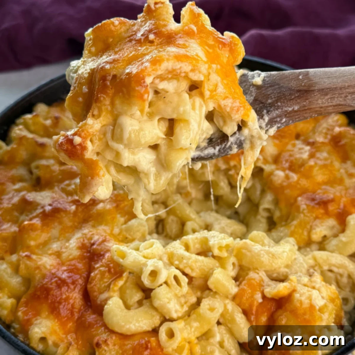 Ultimate Bacon Mac and Cheese 9 southern style baked macaroni and cheese in a baking dish, with a serving spoon