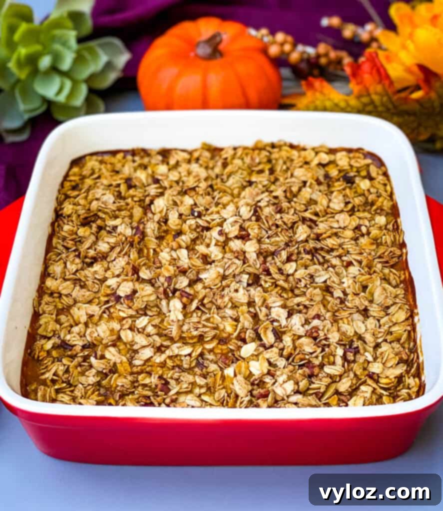 Freshly baked sugar free pumpkin crisp, still bubbling and hot, presented in a vibrant red baking dish, showcasing its inviting golden topping and rich, creamy filling, ready to be cooled and served.