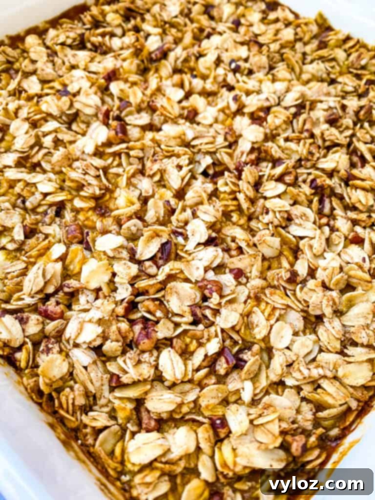 A close-up shot of a perfectly baked sugar free pumpkin crisp, revealing its golden, crunchy oat topping and the rich, inviting texture of the pumpkin filling underneath, ready to be served and enjoyed.