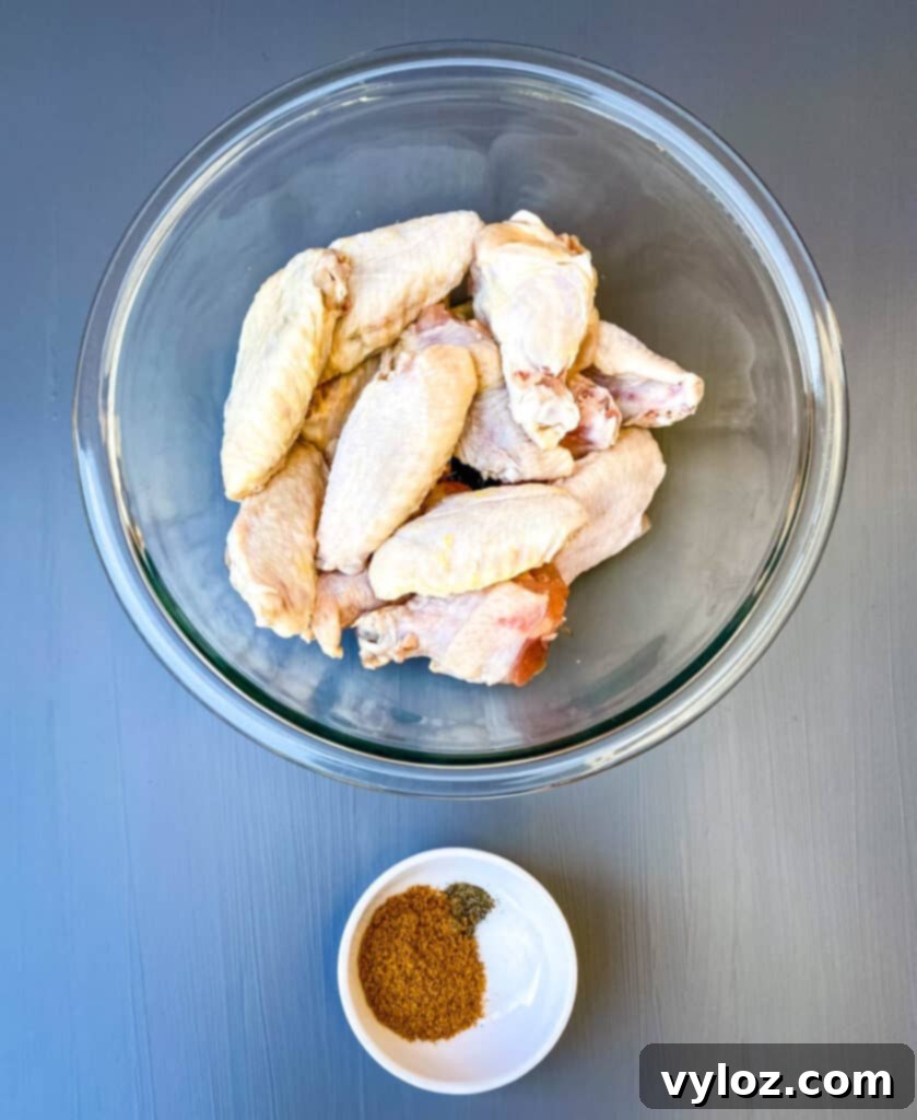 raw chicken wings in a glass bowl