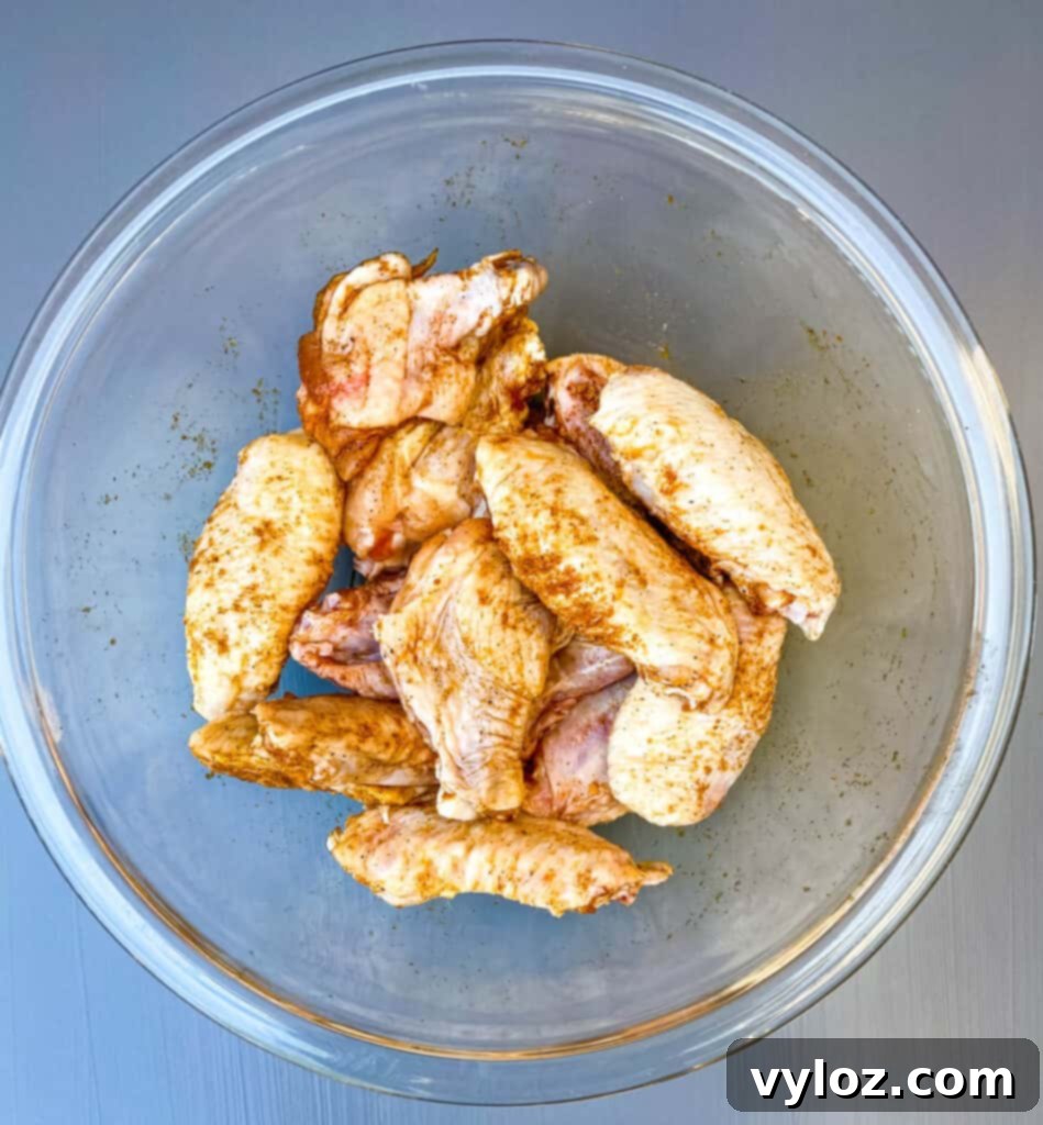 raw chicken wings in a glass bowl