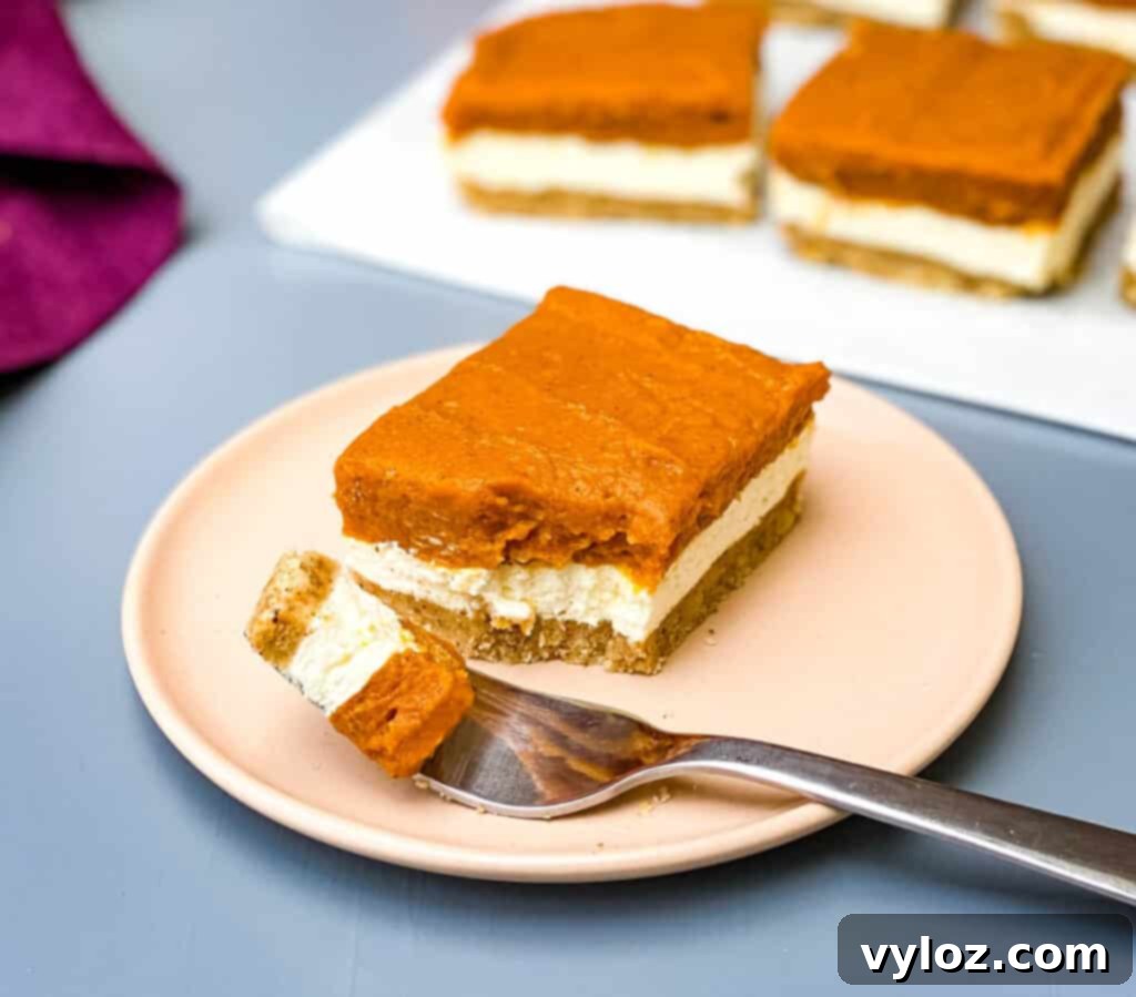 pumpkin cheesecake bars on a pink plate
