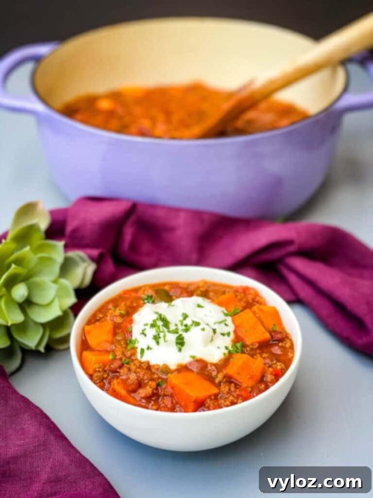 sweet potato chili in a Dutch oven and a white bowl