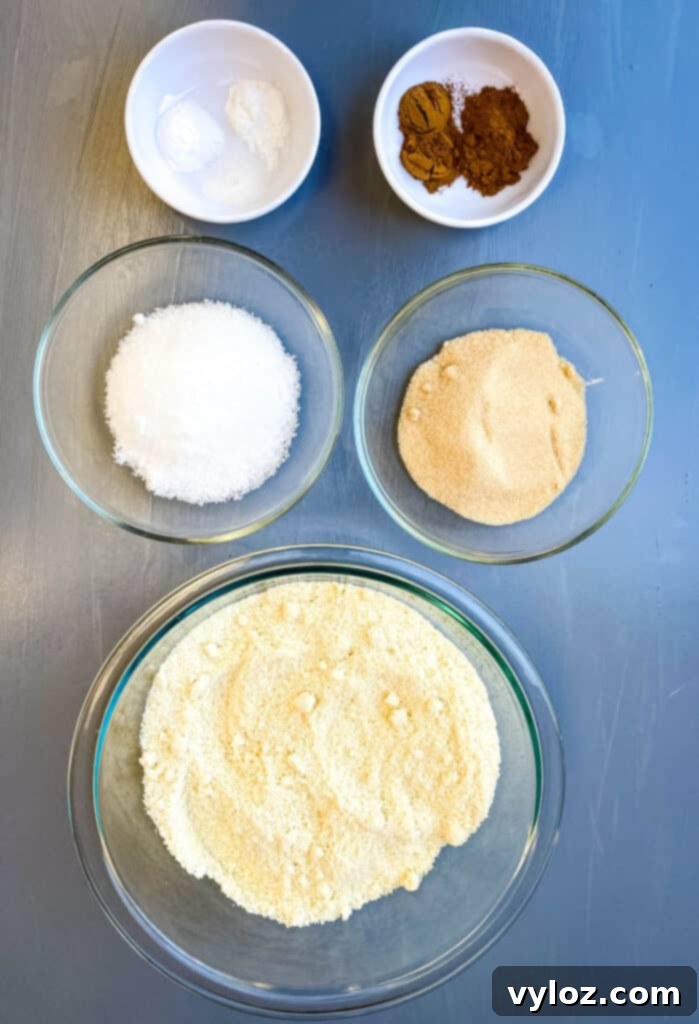 Guilt-Free Pumpkin Spice Cookies 4 almond flour, golden sweetener, white sweetener, pumpkin pie spice, baking powder, and baking soda in separate bowls
