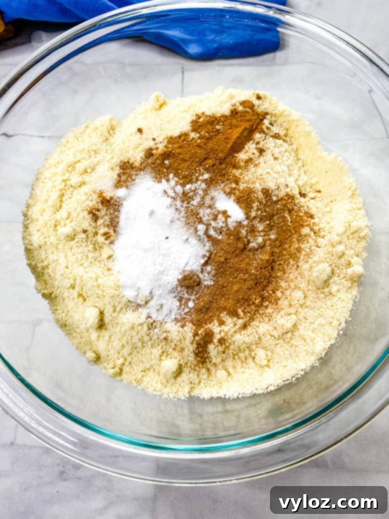 Guilt-Free Pumpkin Spice Cookies 6 almond flour, pumpkin pie spice, baking powder, and baking soda in a glass bowl