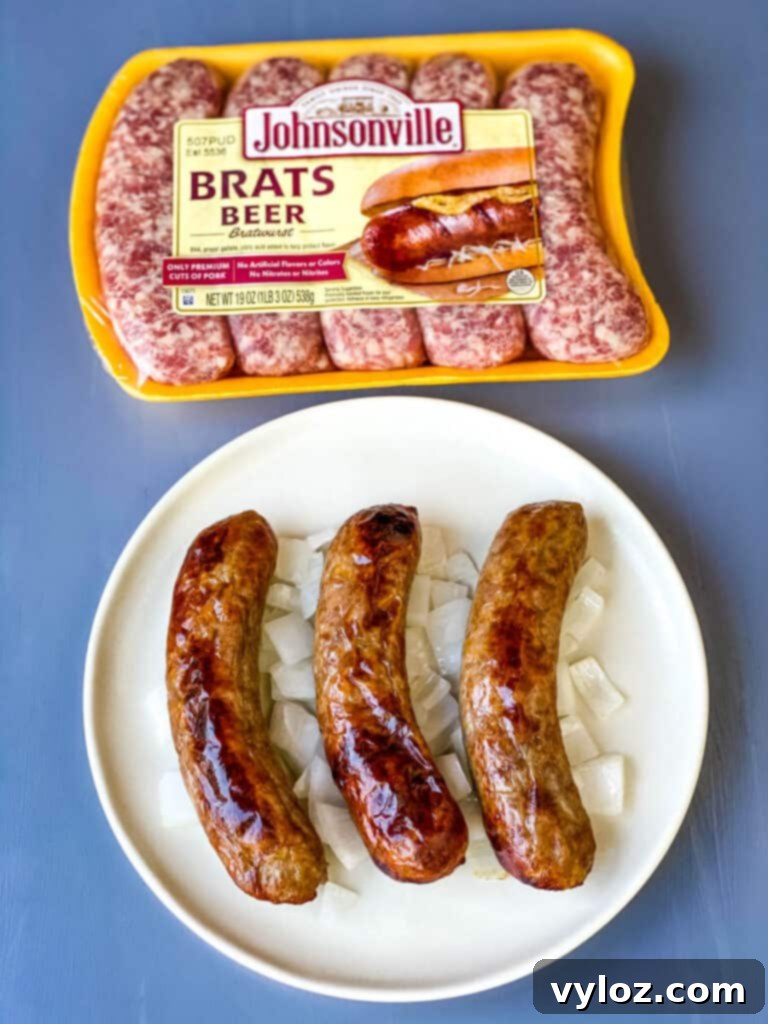 air fryer brats on a plate with onions and mustard