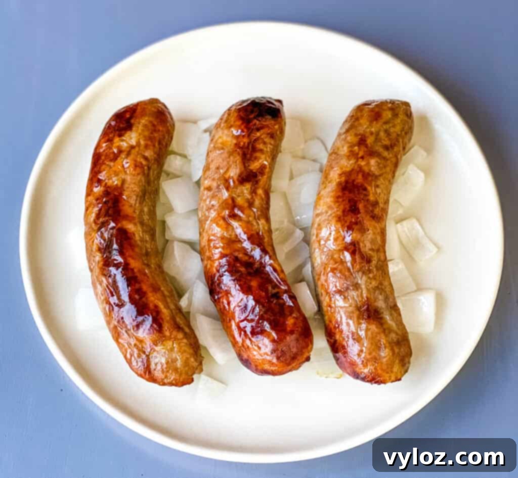air fried brats on a plate with sliced onions