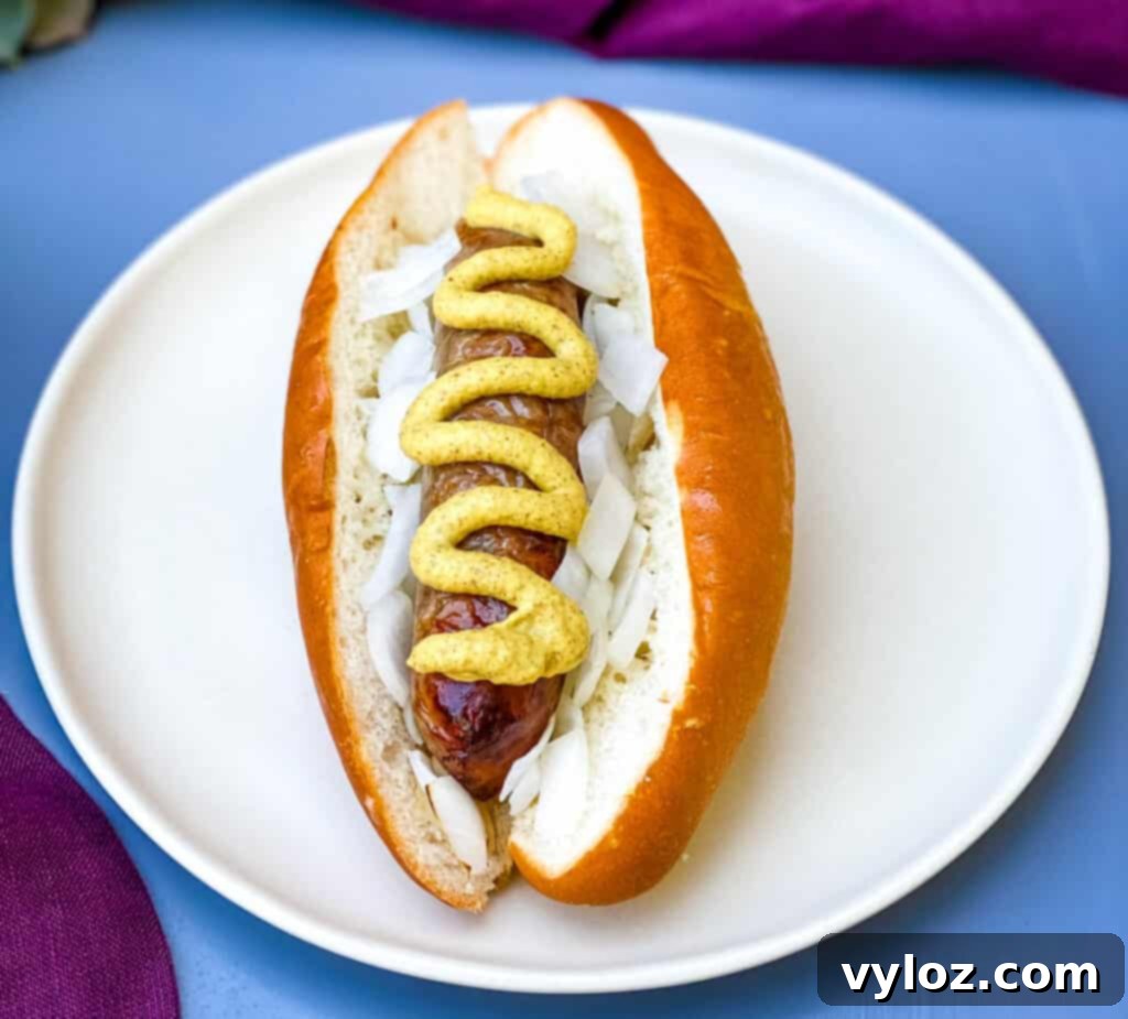 air fryer brat served on a bun with mustard and onions