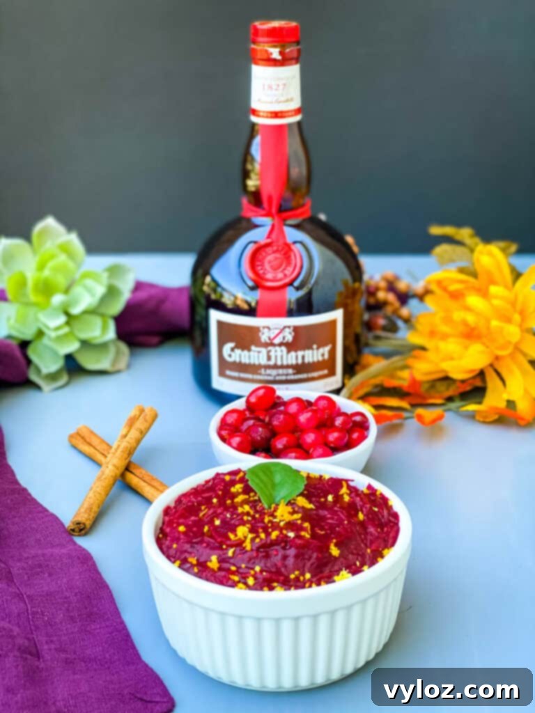 Grand Marnier cranberry sauce in a white bowl with a bottle of Grand Marnier