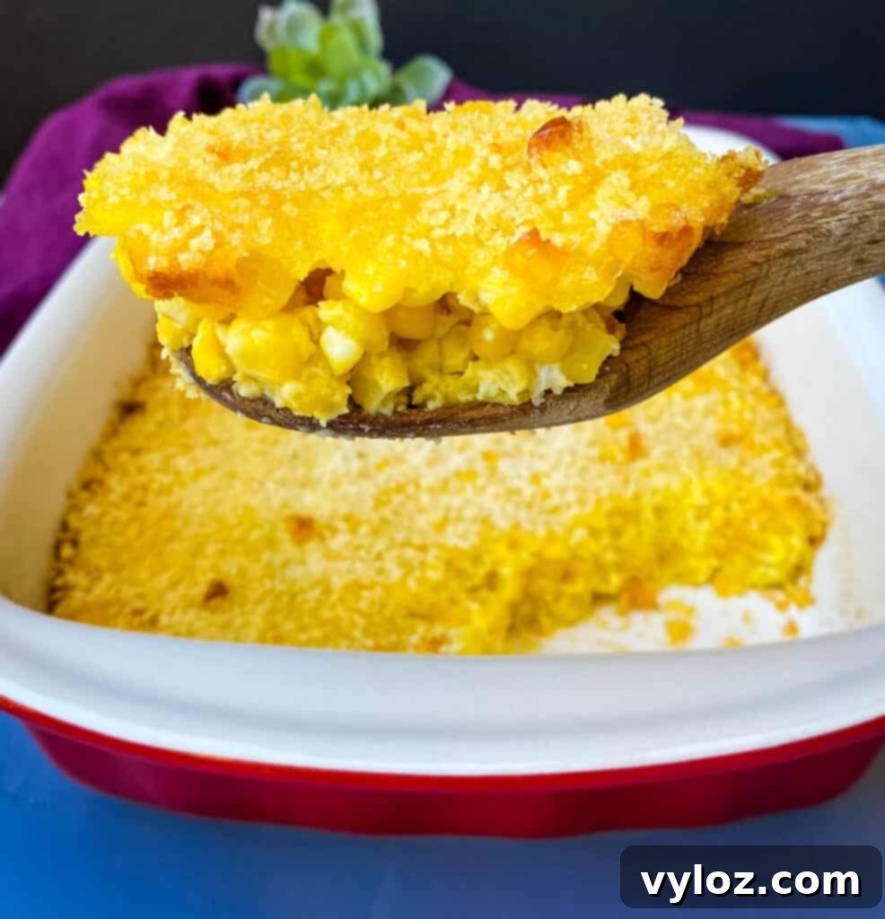 A vibrant, golden-brown scalloped corn casserole, fresh from the oven, promising creamy, sweet corn flavor.
