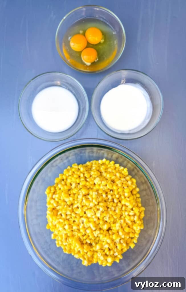 Bowls of raw eggs, heavy whipping cream, almond milk, and whole kernel corn, showcasing the fresh, high-quality ingredients used in the scalloped corn recipe.