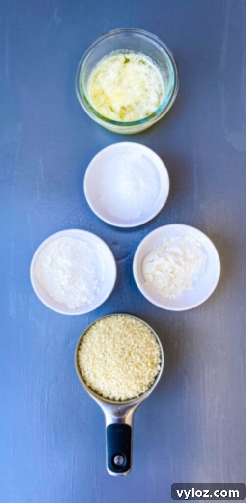 Separate bowls of flour, cornstarch, melted butter, and breadcrumbs, prepped and ready for the scalloped corn casserole.