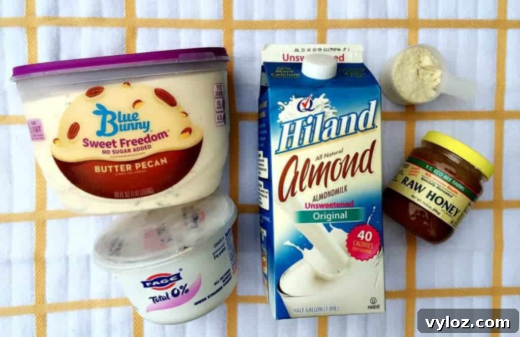 Array of fresh ingredients laid out for a Butter Pecan Protein Smoothie, including milk, yogurt, ice cream, and pecans.