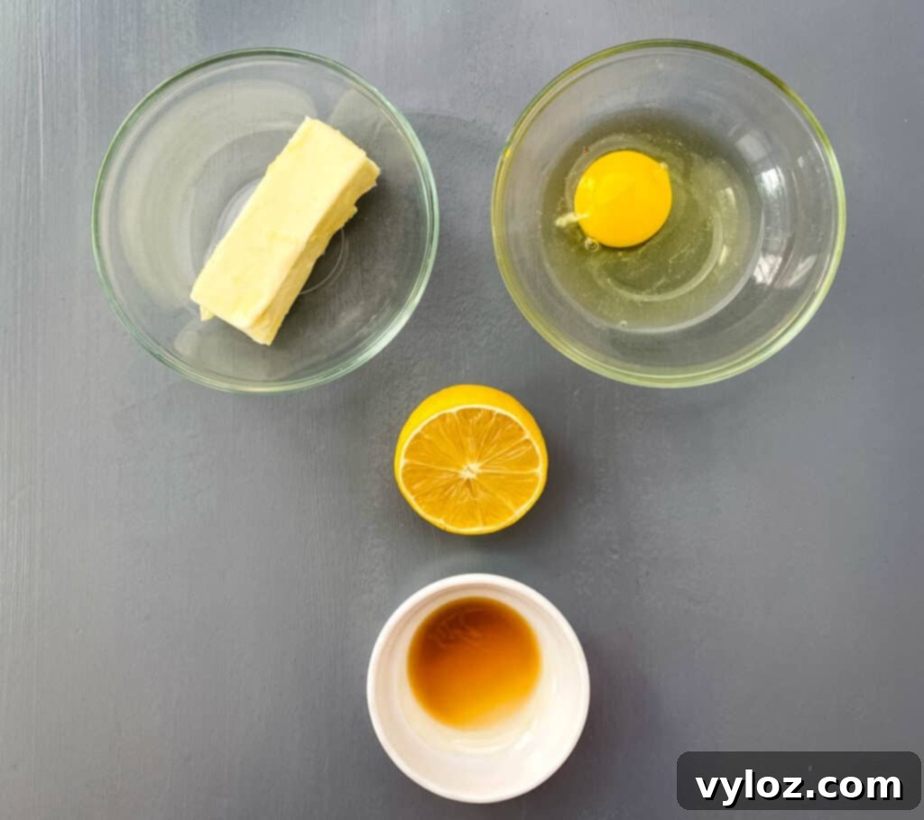 butter, egg, lemon, and vanilla extract on a flat surface