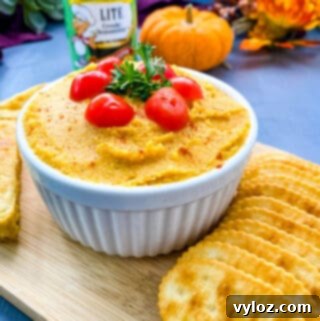 pumpkin hummus on a plate with crackers and cornbread