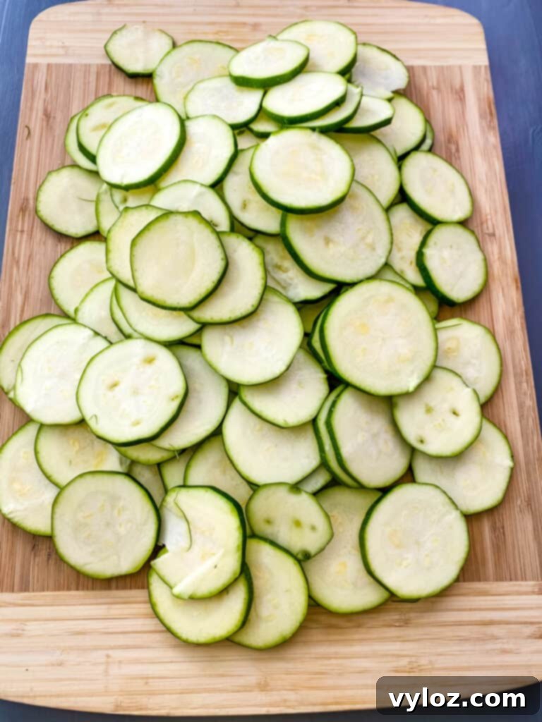 sliced round zucchini on a bamboo cutting board