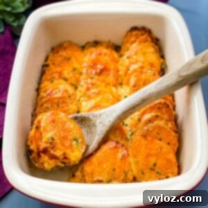au gratin sweet potatoes in a red baking dish