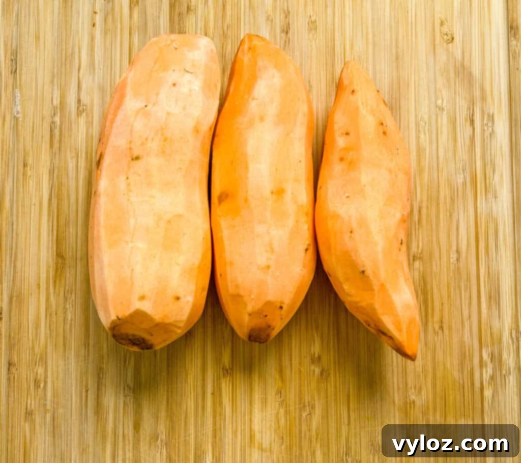 raw sweet potatoes on a cutting board