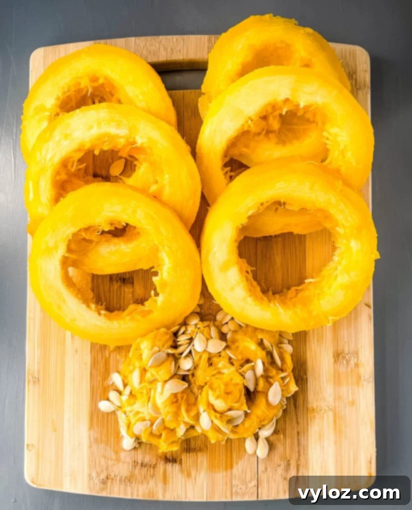 cooked spaghetti squash sliced on a cutting board