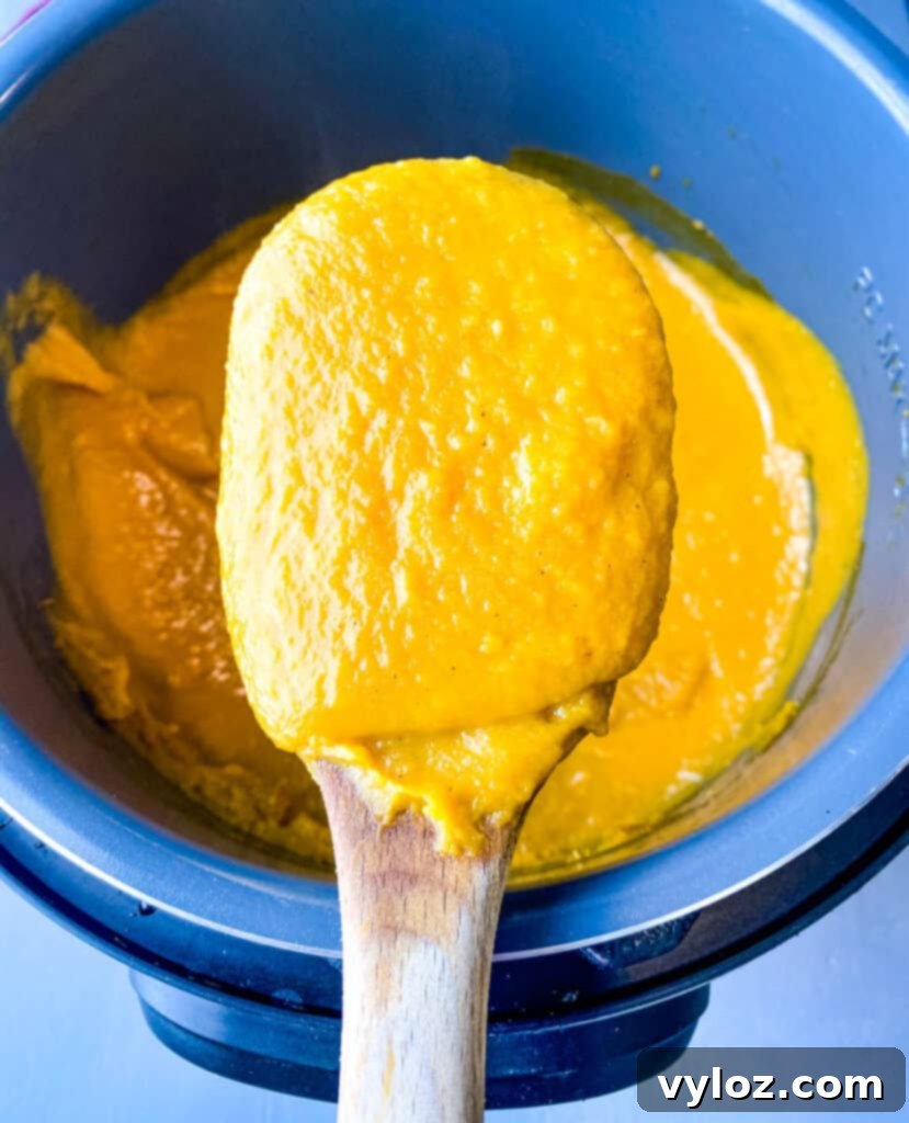 sweet potato soup in a large wooden spoon