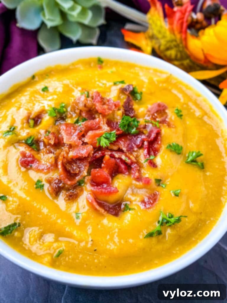 sweet potato soup in a white bowl with chunks of bacon