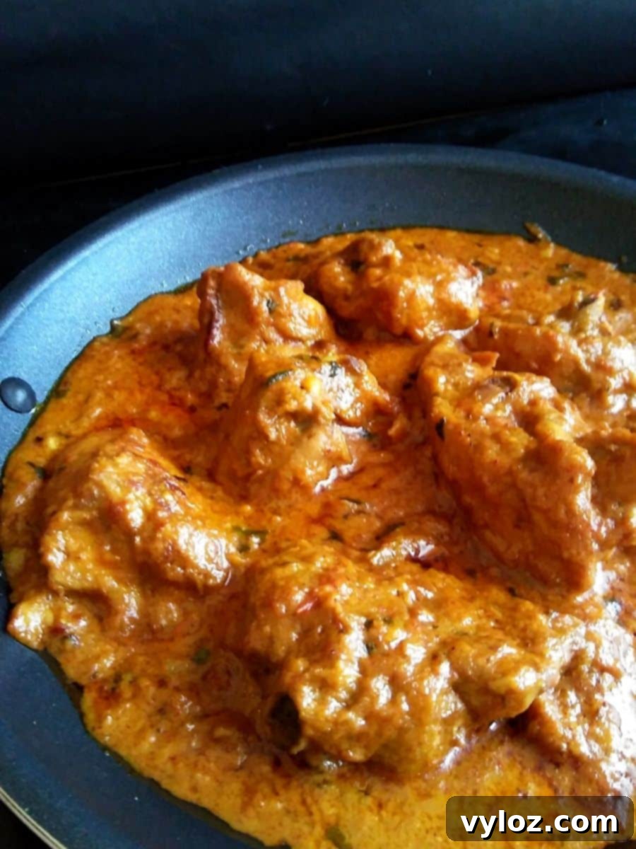 Vibrant and rich Murgh Changezi, a creamy Indian chicken curry, garnished and ready to serve in a pan.