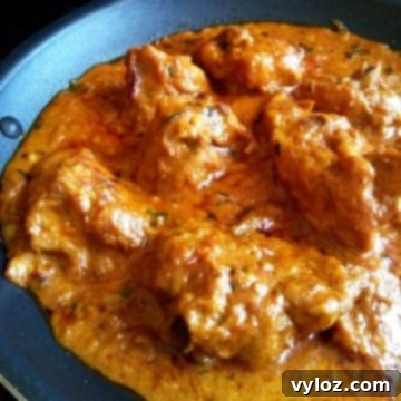 Image showing shahi chicken changezi, a rich and creamy Indian chicken curry, in a nonstick pan.