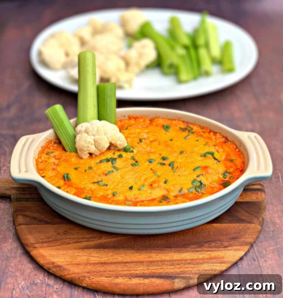 A table spread with ingredients for keto low carb buffalo chicken dip, ready for mixing.