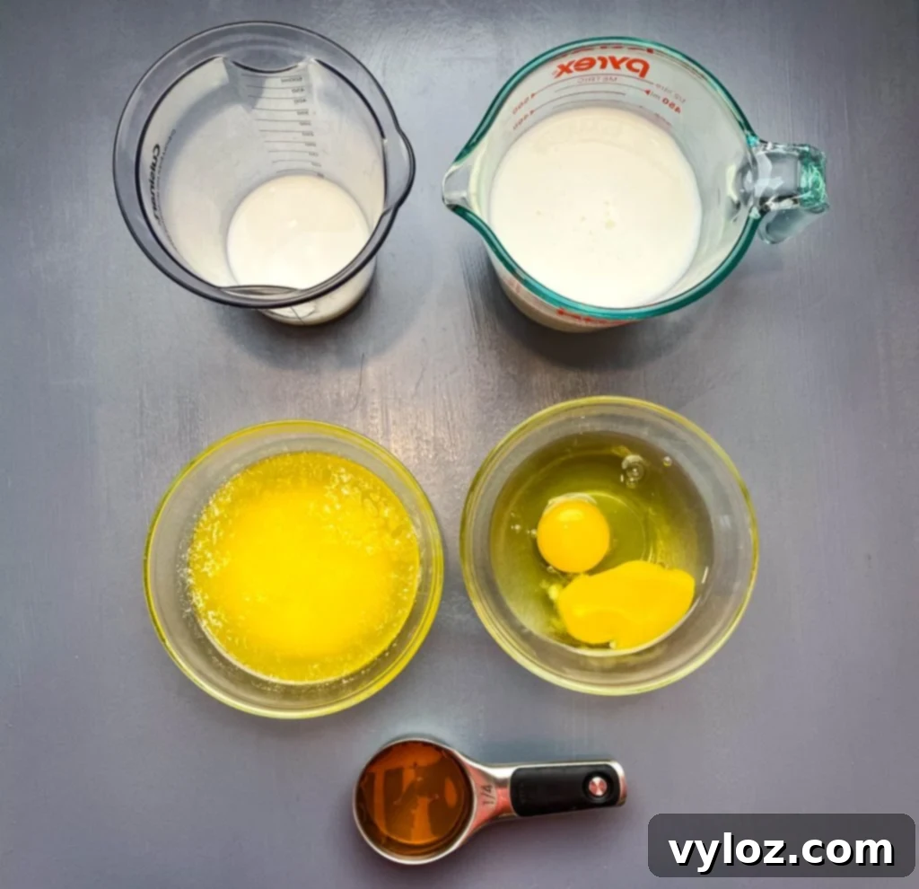 buttermilk, eggs, melted butter, and honey on a flat surface