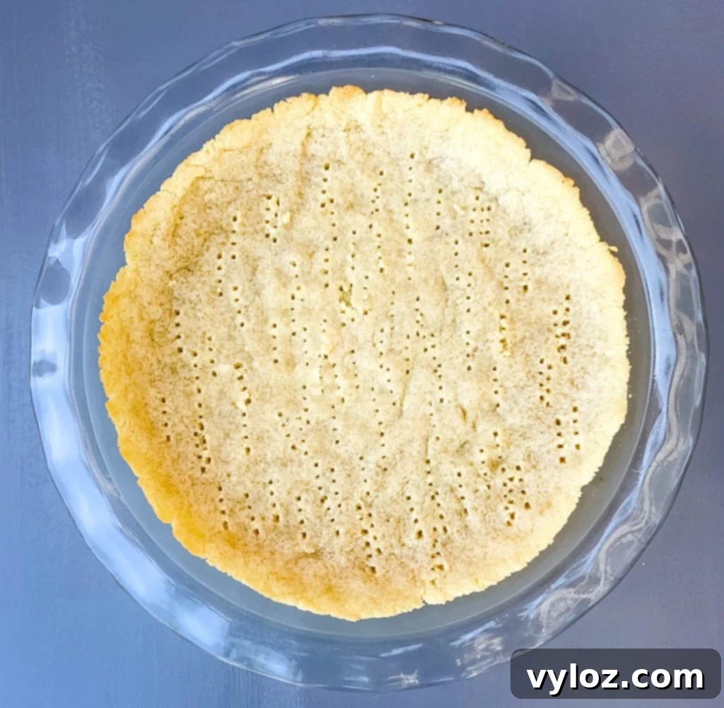 keto pie crust baked in a glass pie plate pan