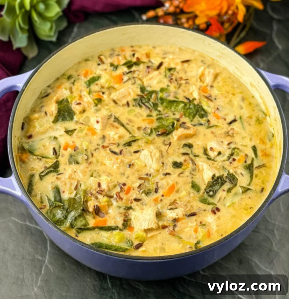 A Dutch oven full of creamy turkey wild rice soup, ready to be served, highlighting its rich texture and hearty ingredients.